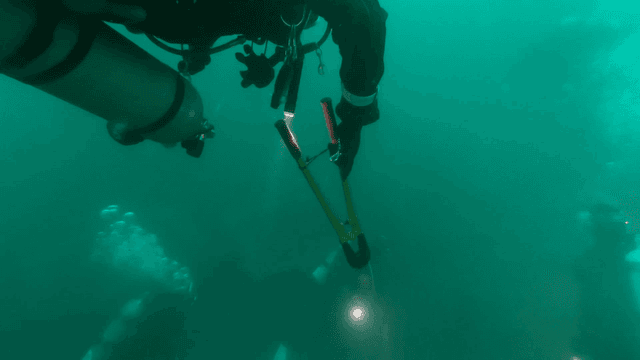 Divers exploring underwater with equipment
