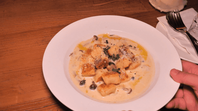 Creamy gnocchi with mushrooms on a table