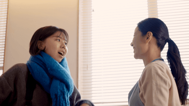 Mother fixes her daughter's scarf every week.