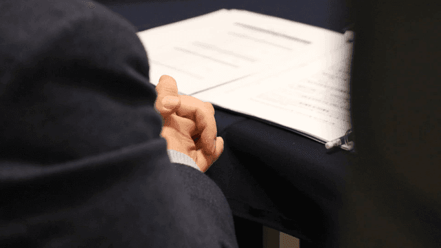 Interviewer holding documents during interview