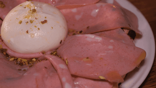 A plate with burrata and mortadella