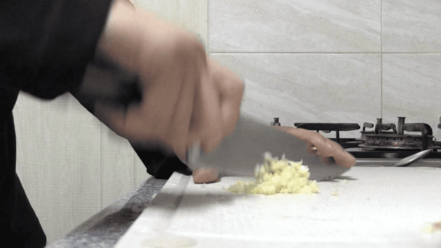 주방에서 마늘을 다지는 모습