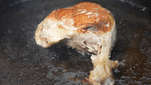 Duck legs roasting in hot pan