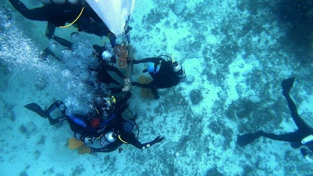 Divers working underwater with lift bag