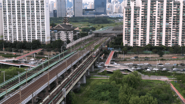 Bustling city with roads and trains