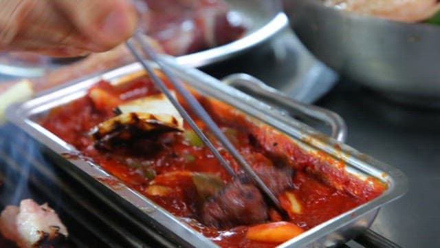 Grilled pork parts served with grilled leeks