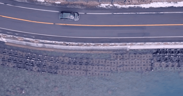 Car driving along a coastal road