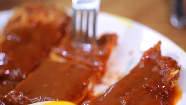 Korean pork cutlet with sauce on a plate