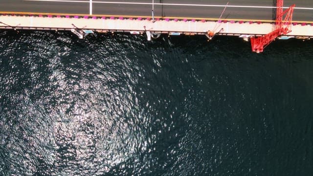 Aerial View of Cars Crossing a Bridge