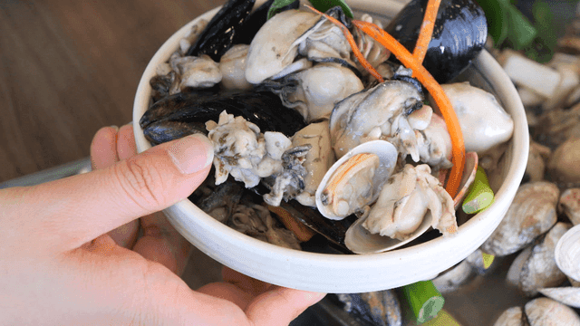 Oyster kalguksu served in generous portion on plate