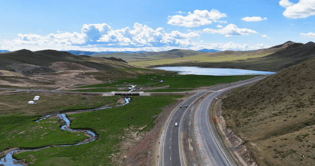 A winding road through green hills