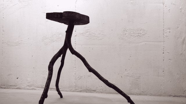 Unique wooden stool in a minimalist room