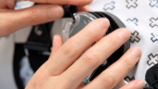 Hands precisely adjusting patient's leg medical aid