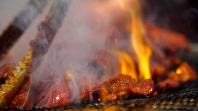 Close-up of Sizzling Pork Belly on a Grill