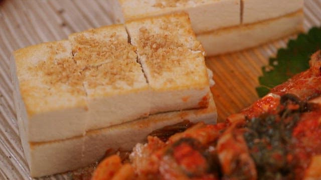 Grilled tofu and kimchi with large-eyed herring on a plate