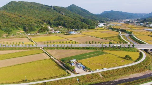 Expansive farmland with mountains in the background