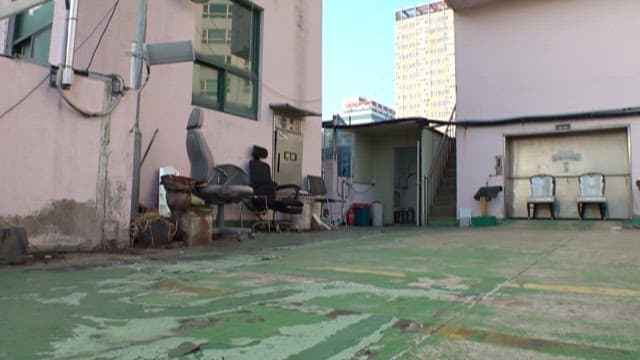 Rooftop of Derelict Building with Abandoned Chairs