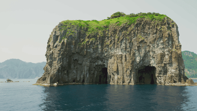 Majestic cliff by the sea with clear water