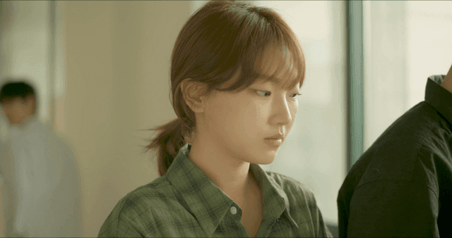 Young uncomfortable woman in green shirt