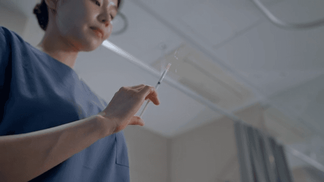 Nurse preparing a syringe in a clinic