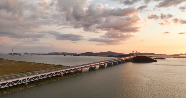 Sunset over a bridge and calm sea