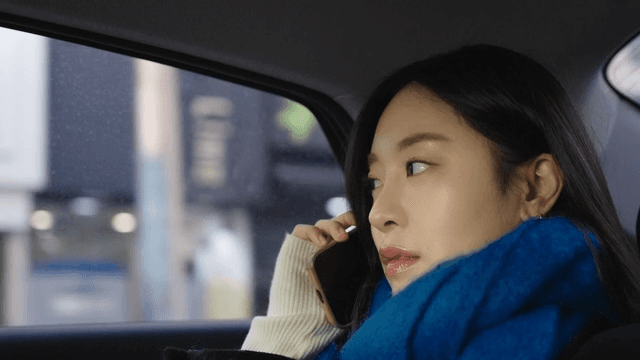 Woman talking on the phone in a taxi