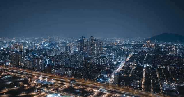 A bustling cityscape at night with lights
