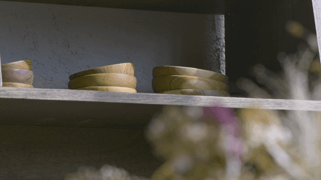 Wooden plate on shelf