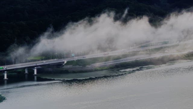 Misty river with a road