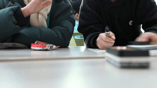Elementary school students studying together at table