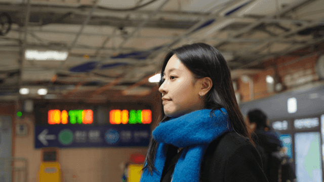 Profile of a woman waiting at a subway station
