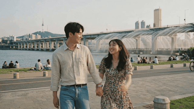 Couple walking by the river in the city