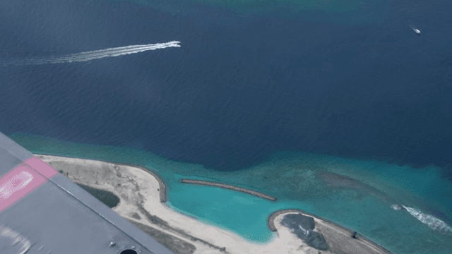 Aerial view of a coastal island with clear waters