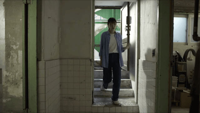 Woman and old man entering old house