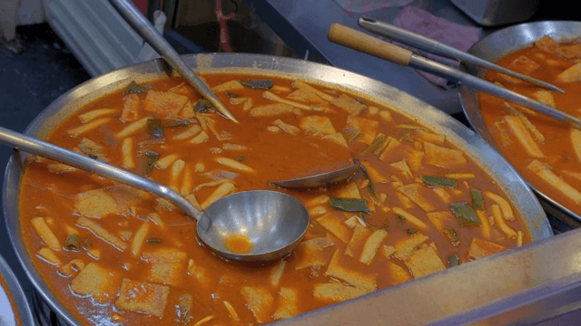 Spicy tteokbokki simmering in a large pan