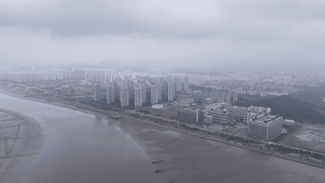 Aerial view of a city with high-rise buildings and a river