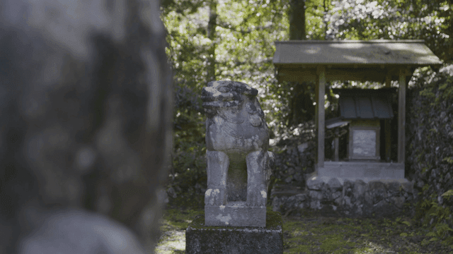 Stone guardian statue in a forest shrine