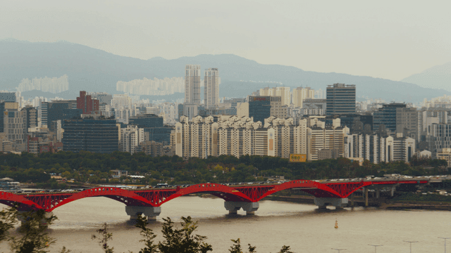 Seoul cityscape with a red bridge over the Han River