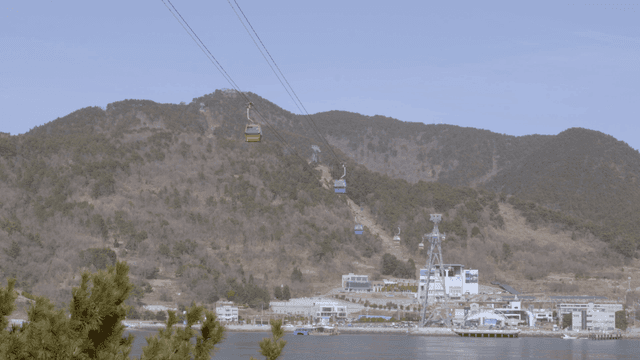 Cable cars moving over a scenic mountain
