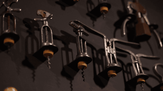Collection of vintage corkscrews on display