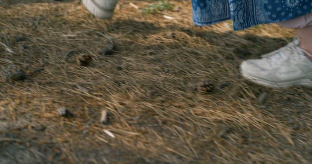 Woman Walking on a Dirt Road with a Backpack