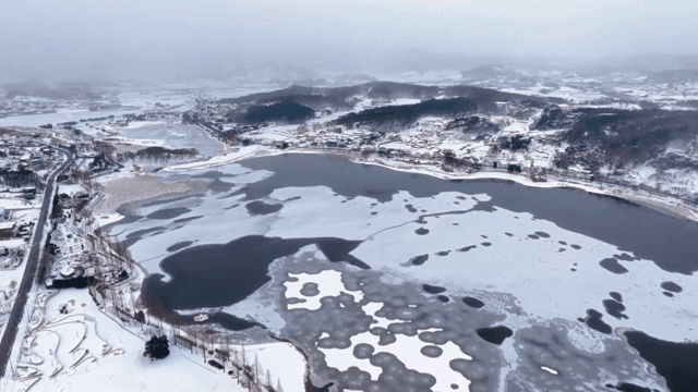 Snow-covered landscape with a frozen lake
