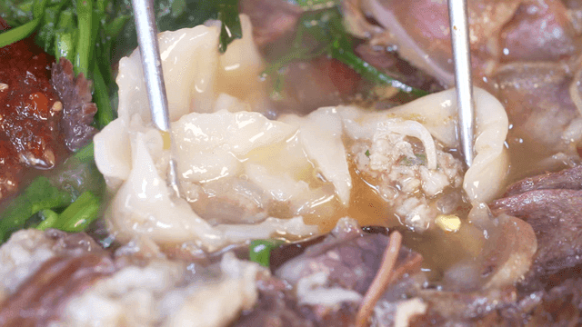 Tear-off dumplings boiling in rich broth
