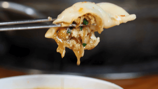Dumpling hot pot lifted with chopsticks