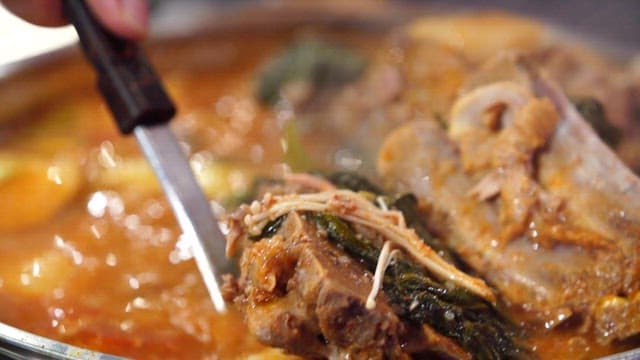 Napa cabbage and pork backbone stew boiling in a pot