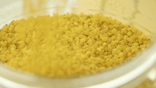 Yellow rice poured into transparent bowl