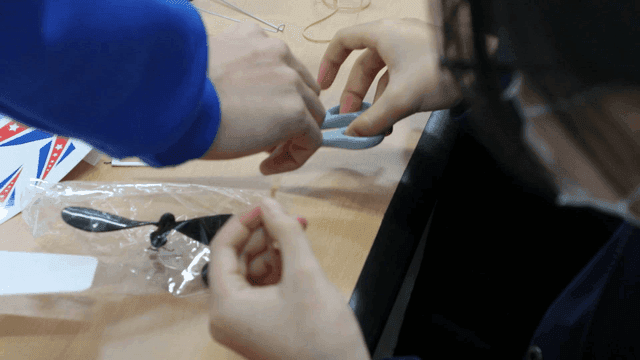 Students assembling a model airplane