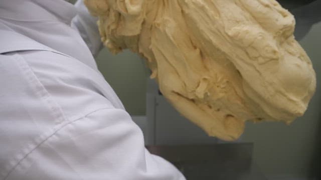 Kneading a large batch of dough in a commercial kitchen