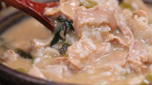 Spoonful of rice with pork soup in a pot