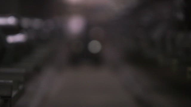 큰 배관 파이프가 있는 공장 통로를 이동하는 로봇